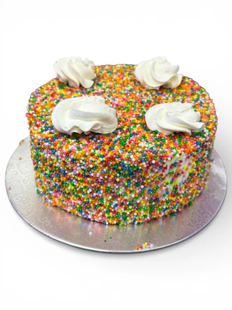 A tall, evenly risen Vanilla eggless cake from Num Num's Bakery, showing the texture a well-balanced egg-free recipe should produce