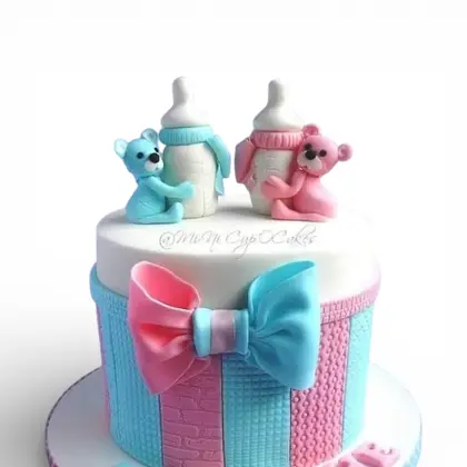 A baby shower cake with fondant bottles and bears